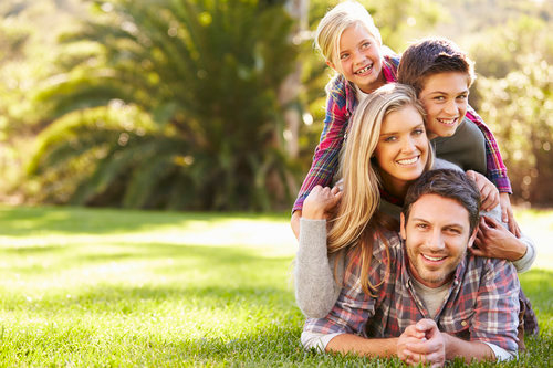 smiling family portrait in the park