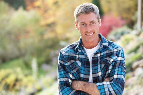 smiling man standing outside