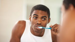 A young man brushing his teeth