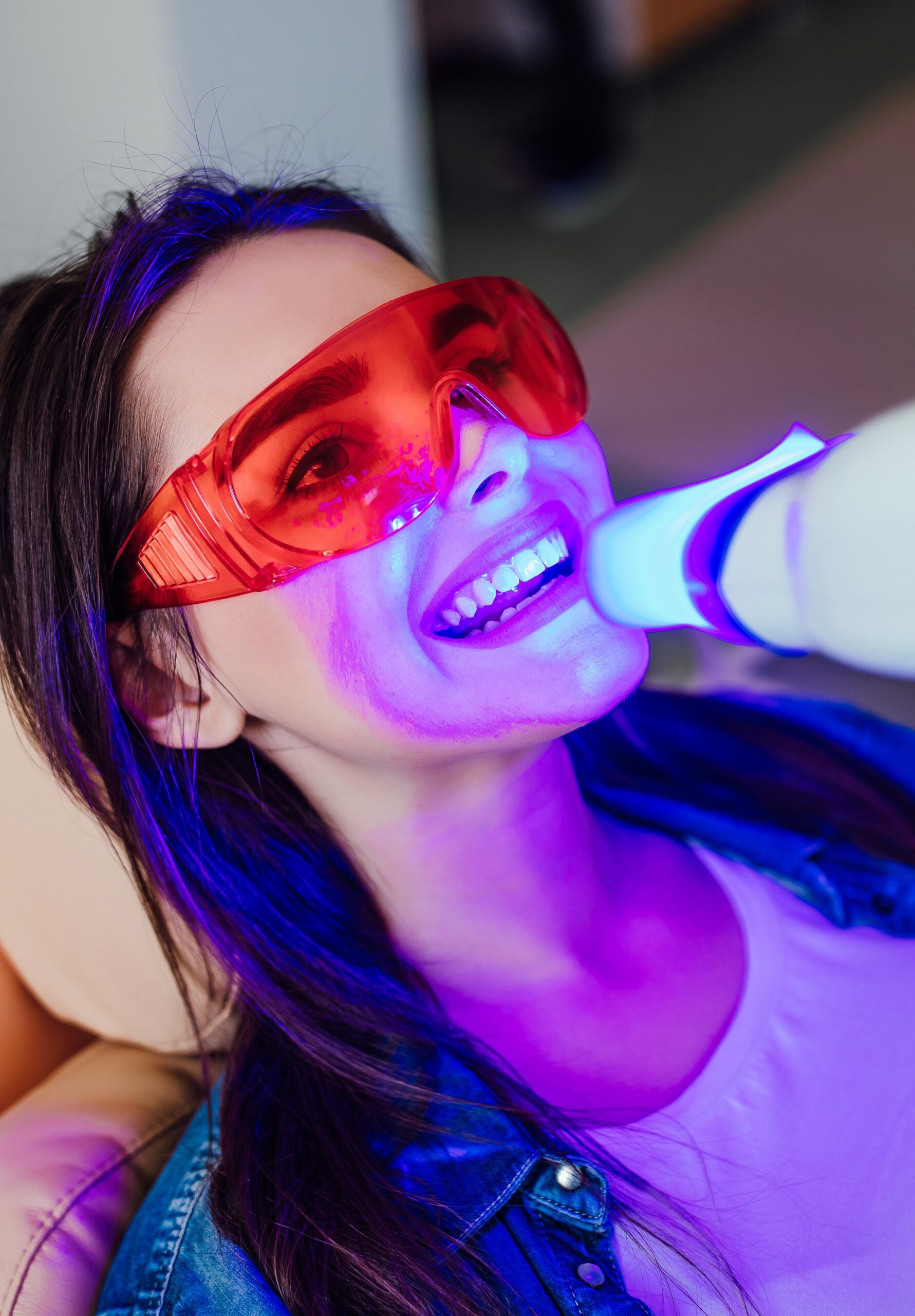 Teeth whitening for woman. Bleaching of the teeth at modern dentist clinic.