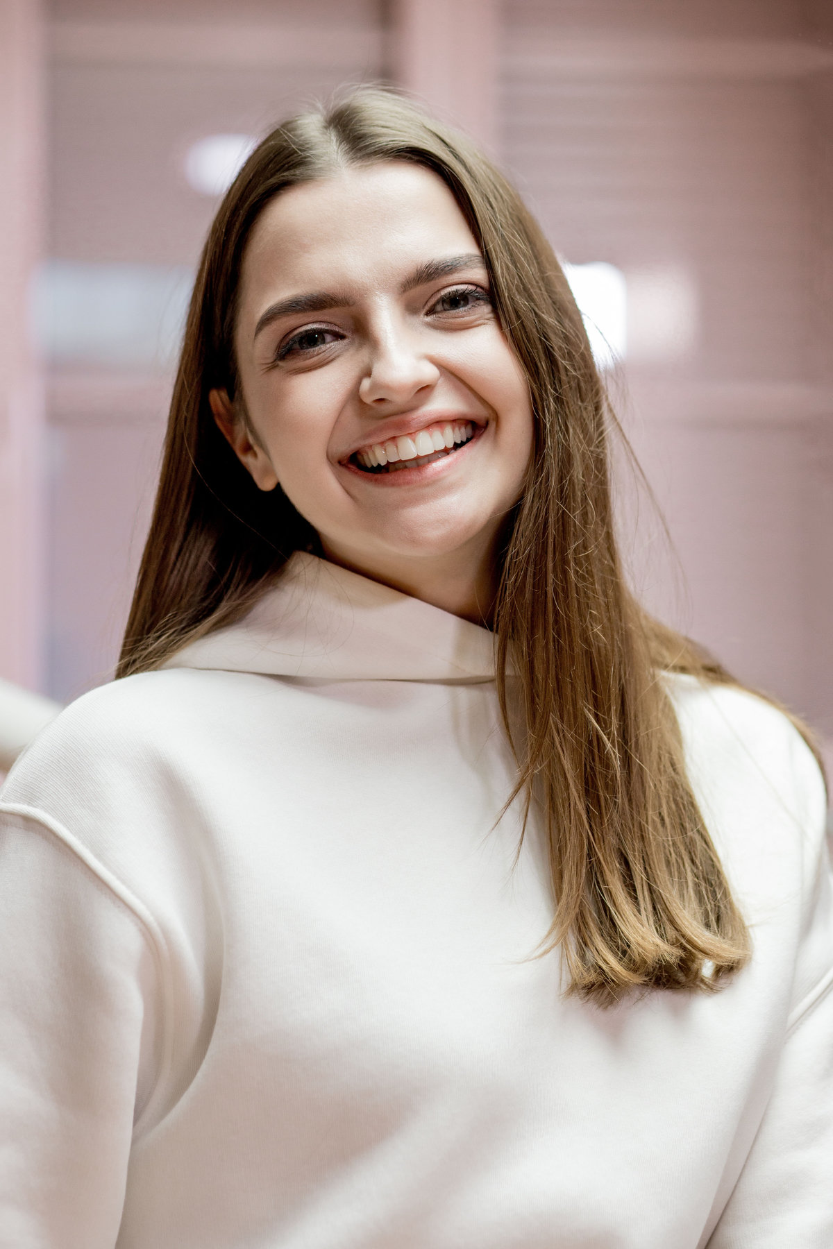 Happy smiling young woman with snow-white smile at dentist reception. Dental care concept.